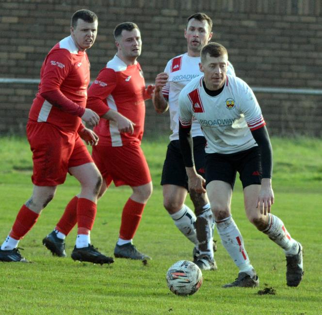 Defender Matthew Davies clears the danger for Clarbeston Road against Milford United